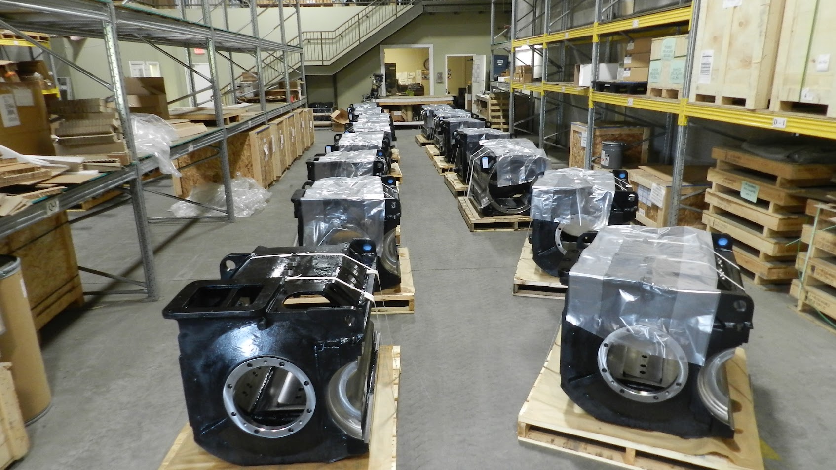 Traction motors staged on warehouse floor between racking bays